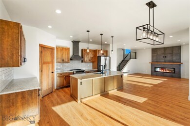 Kitchen with an island with sink, hanging light fi