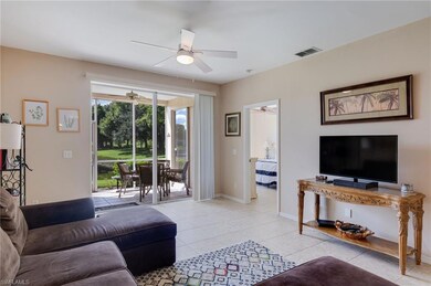 Living room featuring light tile patterned floors and baseboards