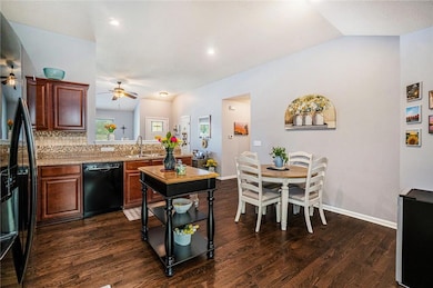 Additional view of the kitchen with a vaulted ceiling.