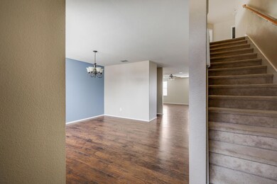 Stairway with wood-type flooring and ceiling fan w