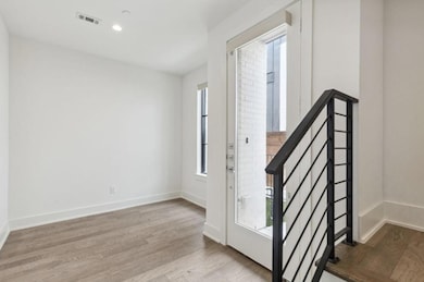 Foyer featuring a healthy amount of sunlight and light hardwood / wood-style flooring