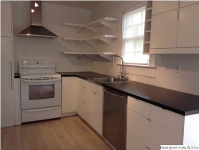 Kitchen with custom cabinets, shelving and high en