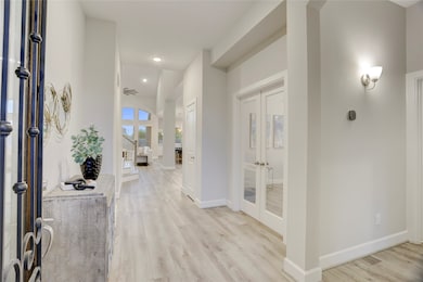 Step into a spacious entryway that opens to high c
