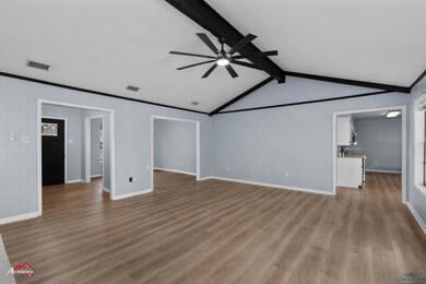 Unfurnished living room featuring lofted ceiling w