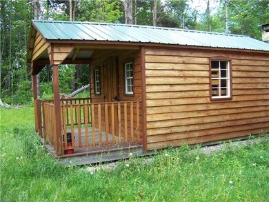 Exterior Front. of cottage in back yard. storage s