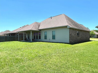 Back of house with a lawn