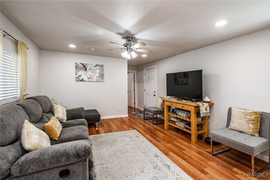 Living room featuring ceiling fan and light hardwo