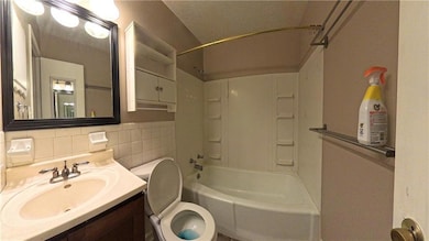 Full bathroom featuring shower / washtub combination, vanity, and tile walls