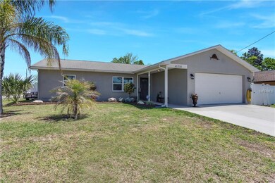 Covered front entry way and palms trees. Gutters a