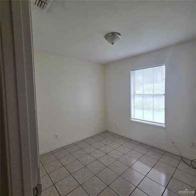 Spare room with light tile patterned floors