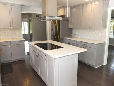 Kitchen has a center island with breakfast bar and