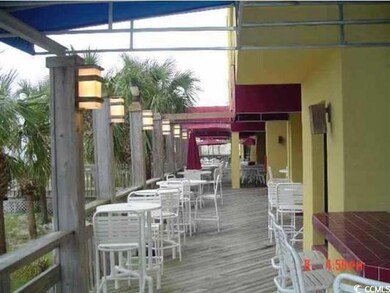 Wooden terrace featuring a bar