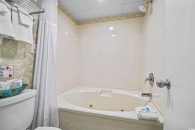 Full bath featuring a combined bath / shower with jetted tub