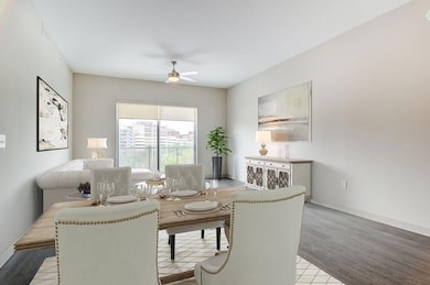 Living room featuring ceiling fan and light hardwo