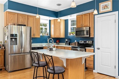 Kitchen with decorative light fixtures, appliances