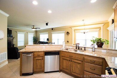 Stained cabinetry with Old World bronze hardware a