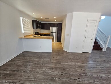Kitchen with stainless steel appliances, dark wood