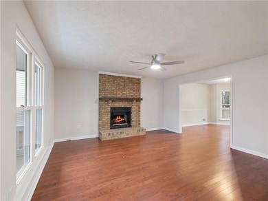 Unfurnished living room featuring dark wood-type f