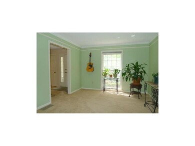Open, formal living room with detailed crown moldi