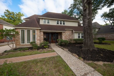 Stone pebble sidewalk leads to double solid wood leaded glass doors.