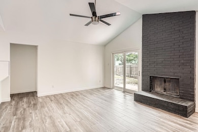 Unfurnished living room with ceiling fan, high va