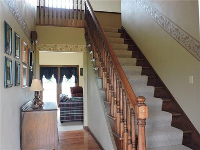 The entry greets you with hard wood floors and a b