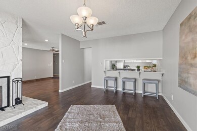 Living room with dark wood-style floors, a firepla