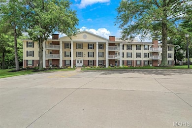 View of building exterior with uncovered parking