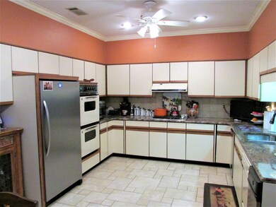 THE KITCHEN ISLAND IS ON WHEELS AND CAN BE MOVED
