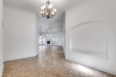 Hall featuring crown molding and a chandelier