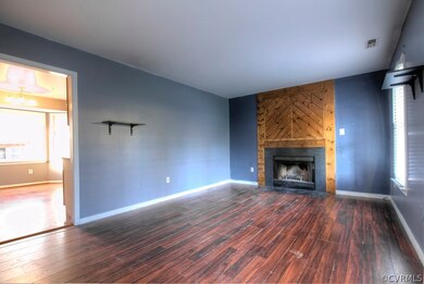 Great room with laminate floors, wood burning fire