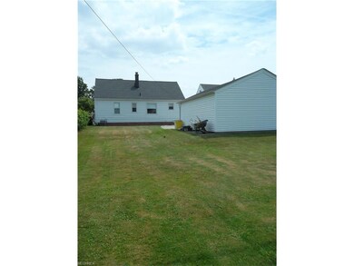 The spacious backyard offers space for entertainin