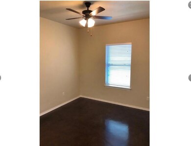 Unfurnished room with baseboards and ceiling fan