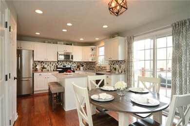 The beautiful kitchen includes hardwood floors, a 