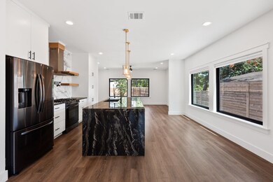 Kitchen with dark wood-style floors, black gas ra