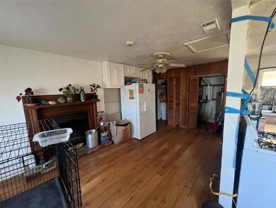 Kitchen with visible vents, a fireplace with raise