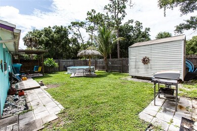 View of yard with a pergola, a patio area, a fenced in pool, and a shed