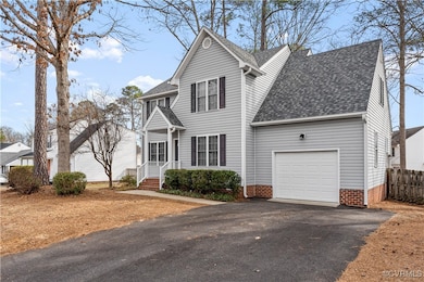 Traditional-style house with a garage, roof with s