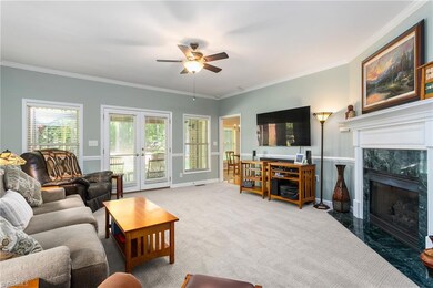 The Great Room with a gas log fireplace is bright and sized perfectly for you.  It opens onto the bricked patio for great flow when entertaining