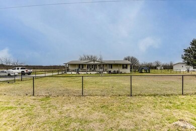 View of front facade with a front yard and fence p