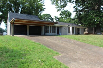 Ranch-style home featuring a garage and a front la