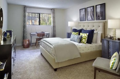 Bedroom featuring carpet floors and a textured cei