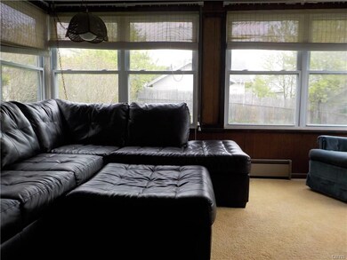 Four season sun room with replacement windows whic