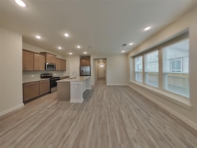 Kitchen featuring light wood-style flooring, base