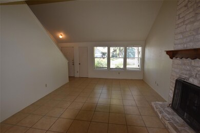 Unfurnished living room with vaulted ceiling, a f