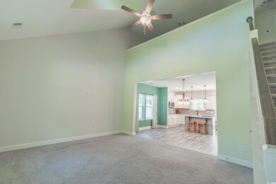 Unfurnished living room featuring light colored ca