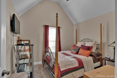 Carpeted bedroom featuring lofted ceiling