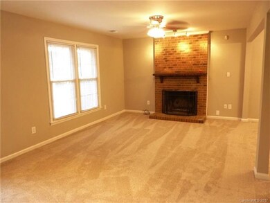 Family Room with brick wood burning fire place. Th