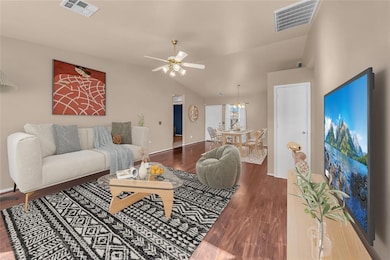Living room featuring lofted ceiling, ceiling fan,