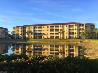 View of apartment building / complex featuring a water view